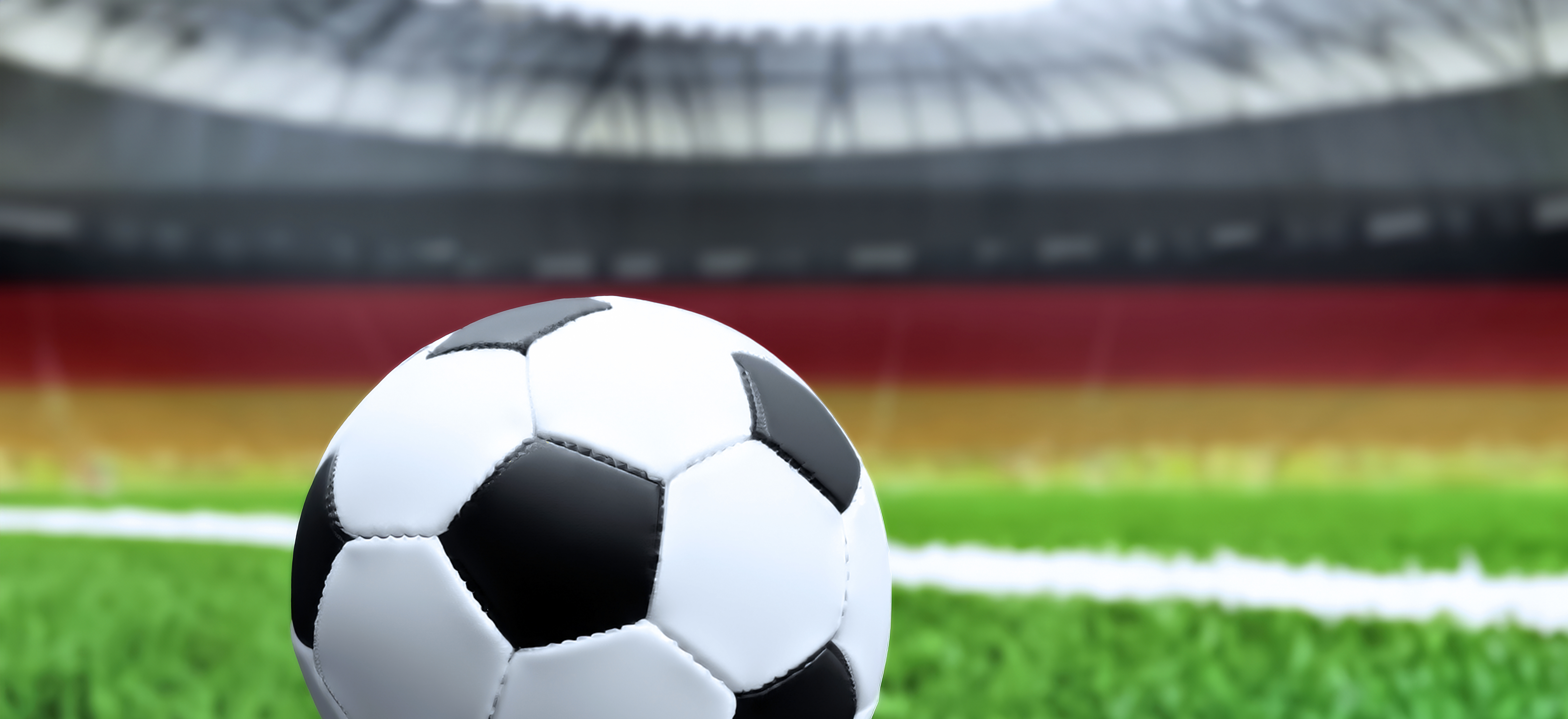 Fusßball im Stadion mit deutscher Flagge im Hintergrund Fusßball im Stadion mit deutscher Flagge im Hintergrund